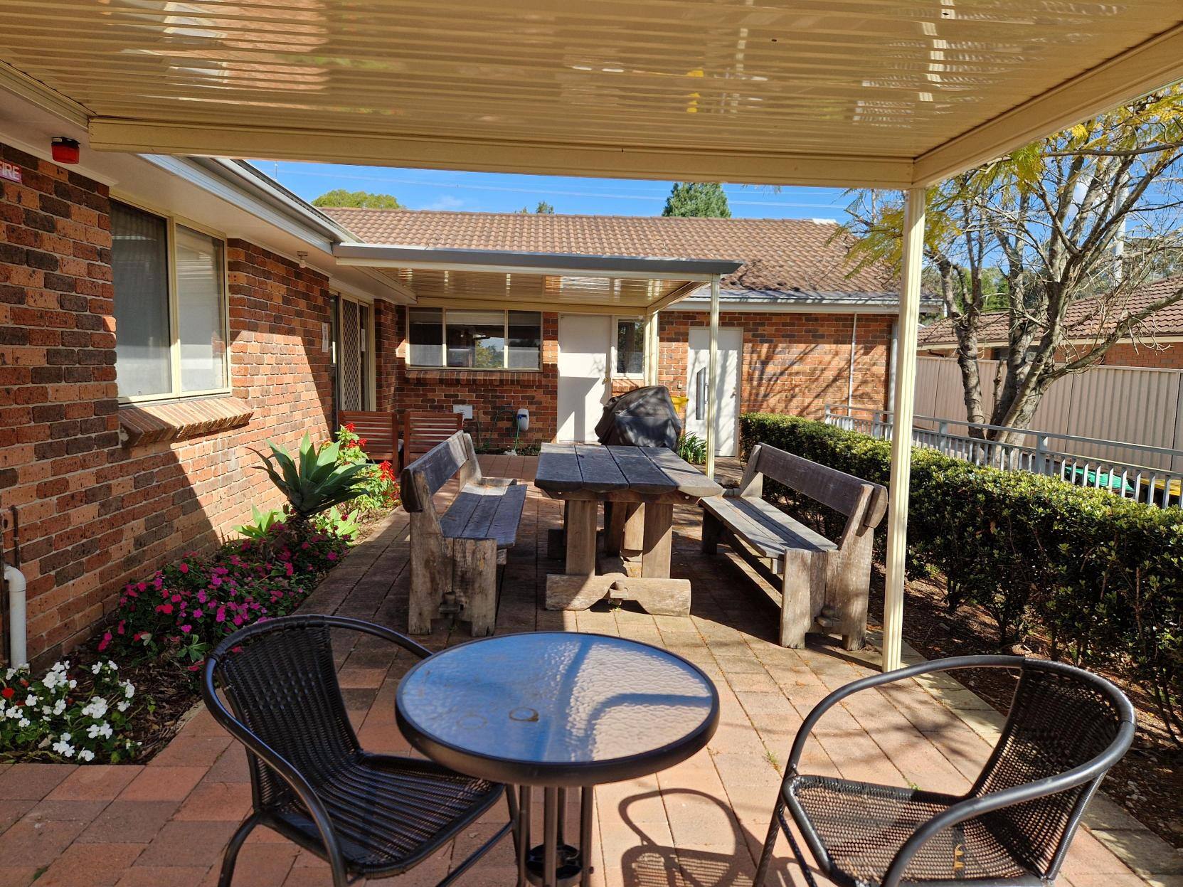 A patio setup with a table and chair.