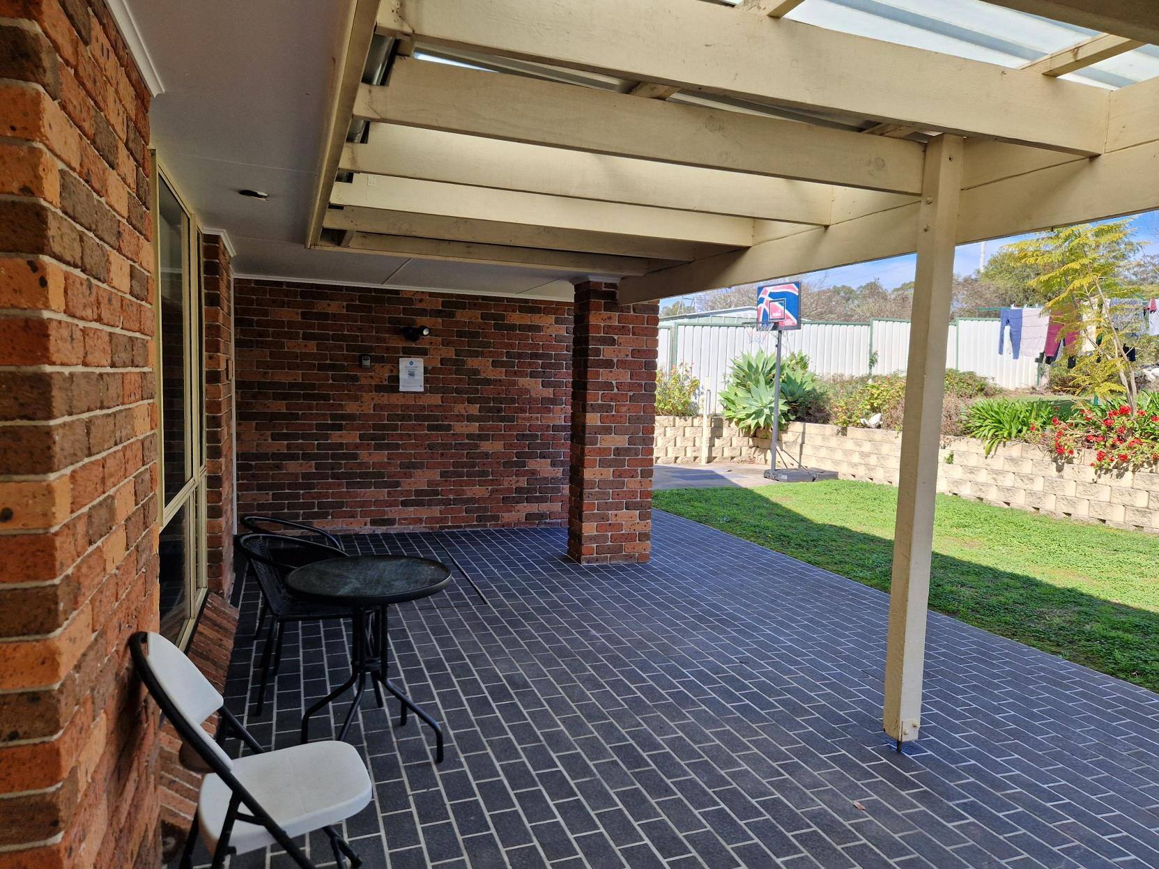 Large patio with a small table and two chairs.