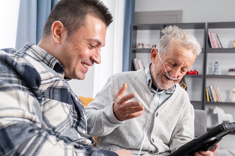 Volunteer | ACVVS | Two men smiling in in Aged Care facility