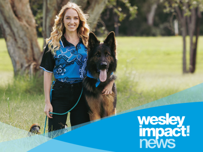 Woman and dog enjoying support for homeless youth in the park.